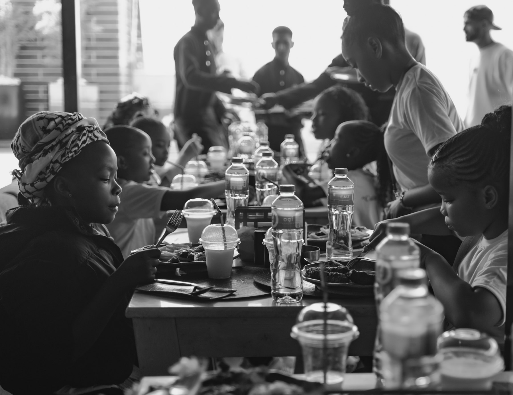 Neighbors sharing a meal around a long community table
